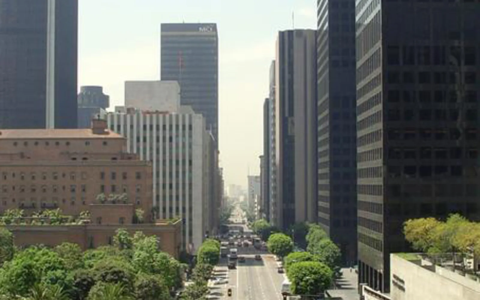 Downtown street scene showing pedestrian areas, storefronts, and pedestrian bridges creating a walkable urban environment